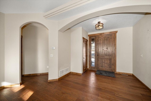 foyer entrance featuring dark wood-type flooring