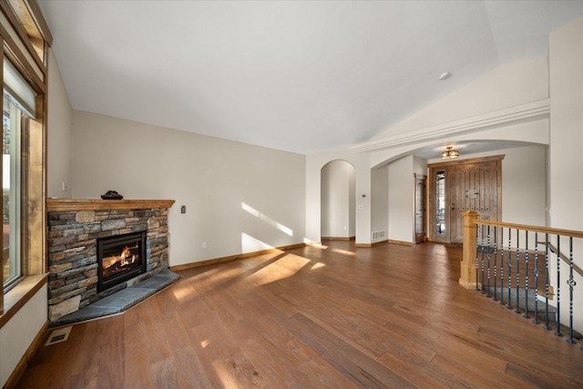 living room featuring hardwood / wood-style floors, a fireplace, and vaulted ceiling