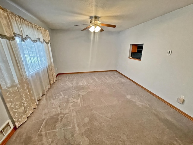 empty room featuring light carpet and ceiling fan