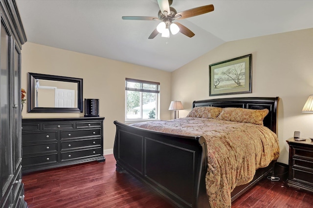 bedroom featuring dark hardwood / wood-style flooring, vaulted ceiling, and ceiling fan