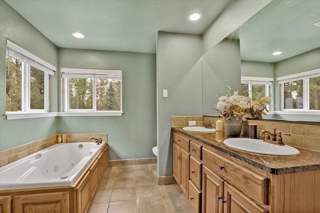 bathroom with toilet, vanity, tile patterned flooring, decorative backsplash, and a washtub