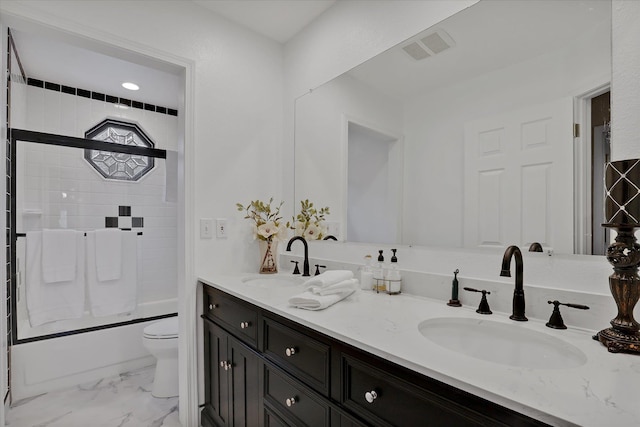 full bathroom featuring bath / shower combo with glass door, vanity, and toilet