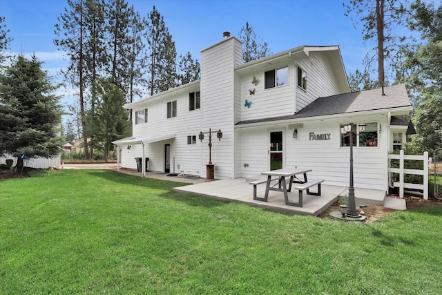 back of house featuring a patio and a lawn