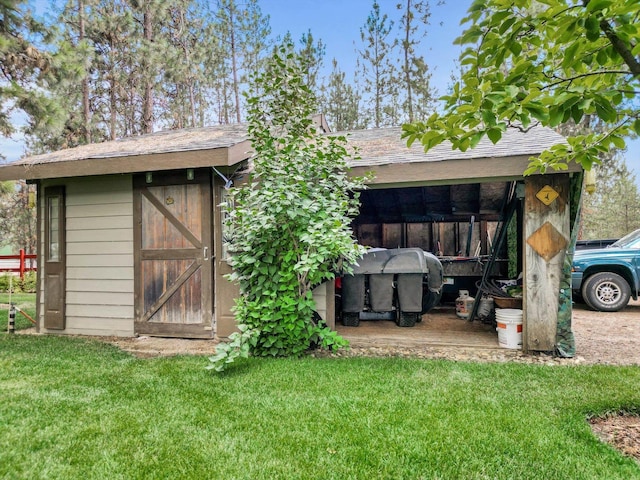 view of outbuilding featuring a yard