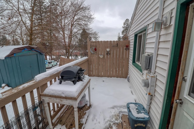 snow covered deck with area for grilling