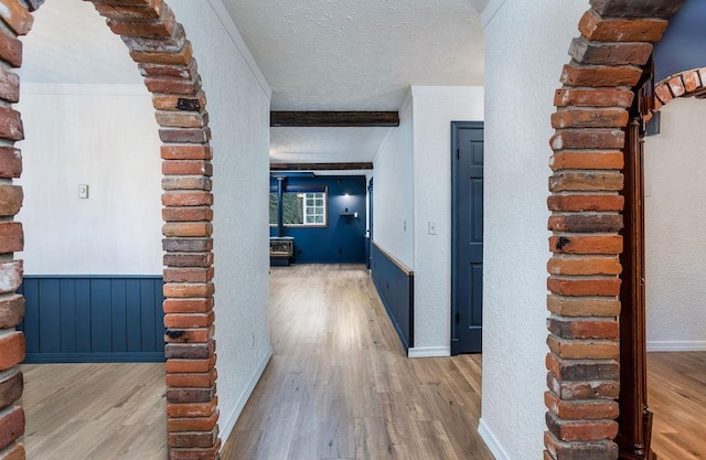 hall with hardwood / wood-style floors and a textured ceiling