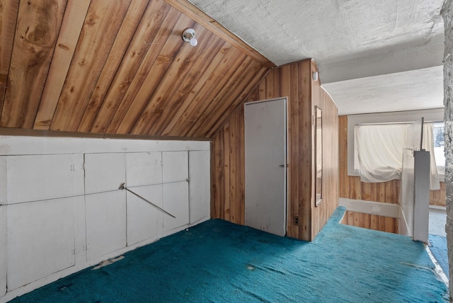 bonus room with lofted ceiling, wood ceiling, and wooden walls