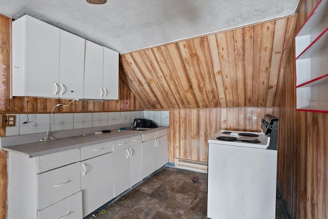 kitchen with white cabinetry, vaulted ceiling, a textured ceiling, wooden walls, and electric stove