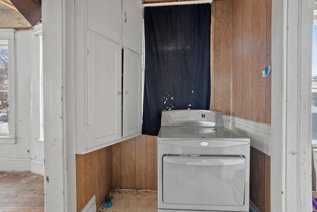 kitchen featuring washer and dryer and wood walls