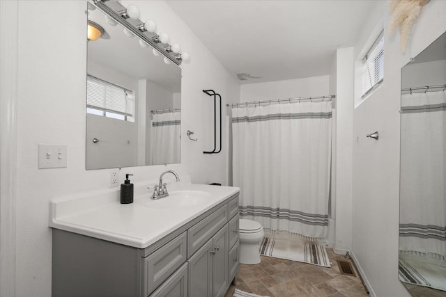 bathroom with vanity, toilet, and a shower with shower curtain