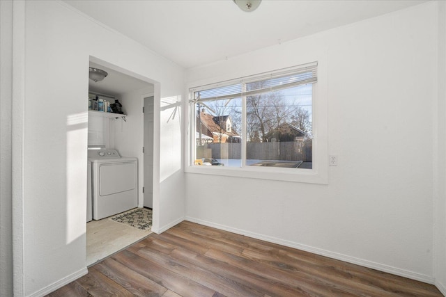 laundry area with hardwood / wood-style floors and washer / dryer