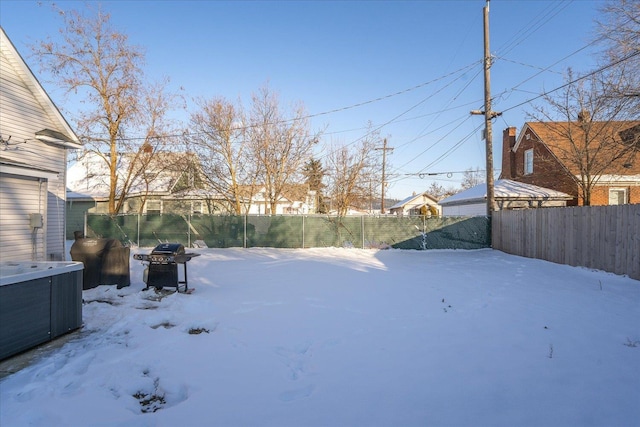 yard layered in snow featuring a hot tub