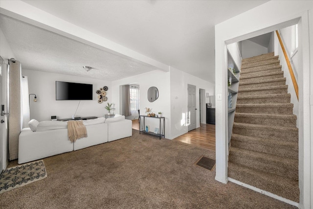 living room with carpet floors and a textured ceiling