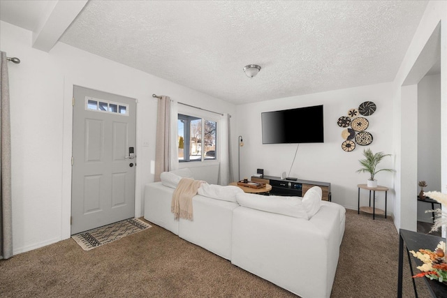 carpeted living room with beamed ceiling and a textured ceiling