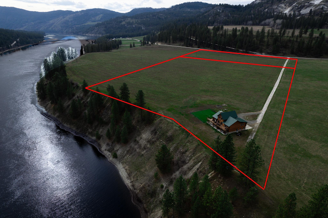 drone / aerial view featuring a water and mountain view and a rural view