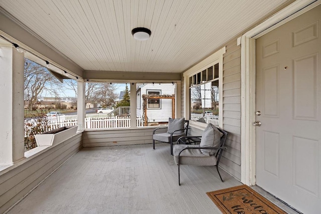 sunroom featuring wooden ceiling