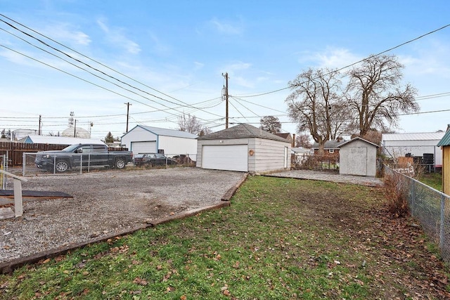 view of yard with a storage unit and a garage