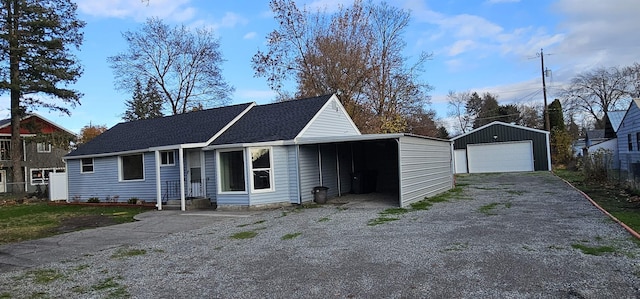 exterior space with a garage, an outbuilding, and a carport