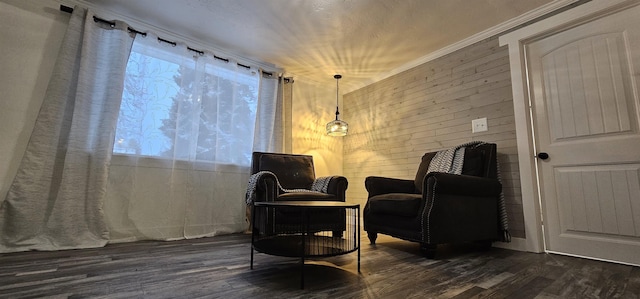 sitting room with crown molding, wood walls, and dark hardwood / wood-style floors