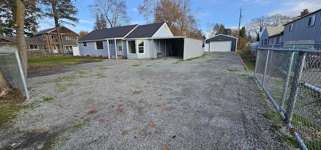 view of front facade with a garage and an outbuilding