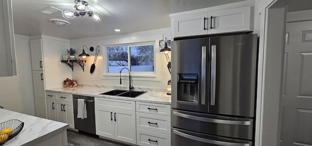 kitchen with sink, white cabinetry, stainless steel fridge with ice dispenser, and dishwasher