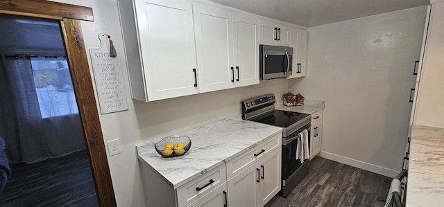 kitchen featuring white cabinets, appliances with stainless steel finishes, and light stone countertops