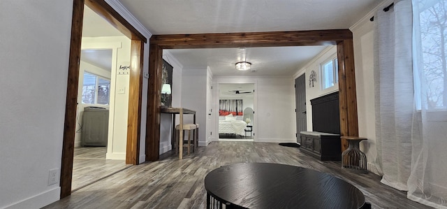 hall featuring hardwood / wood-style flooring, washer / dryer, and crown molding