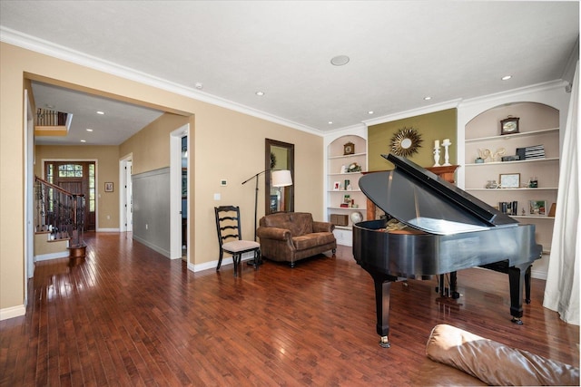 living area with crown molding, built in shelves, and dark wood-type flooring