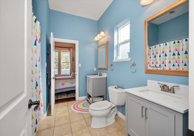 bathroom featuring tile patterned flooring, vanity, and toilet