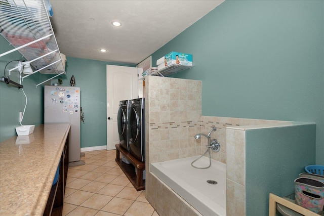 bathroom with tile patterned floors and washing machine and dryer