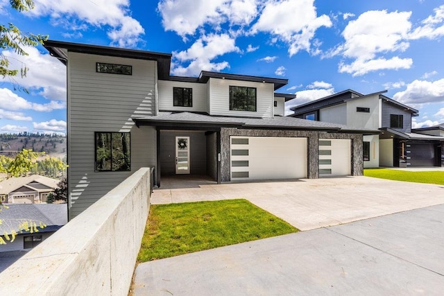 5022 S Lincoln Way, Spokane, WA 99224 - modern home featuring concrete driveway, a garage, and a front yard