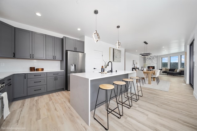 5022 S Lincoln Way, Spokane, WA 99224 - kitchen with stainless steel fridge with ice dispenser, light wood finished floors, gray cabinets, a sink, and light countertops