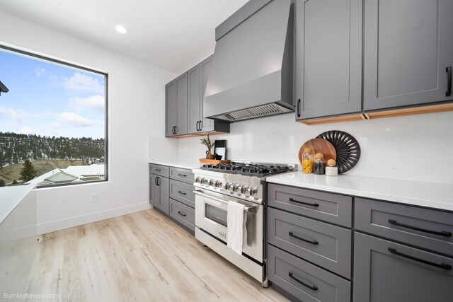 5022 S Lincoln Way, Spokane, WA 99224 - kitchen featuring high end range, gray cabinets, wall chimney exhaust hood, light countertops, and recessed lighting