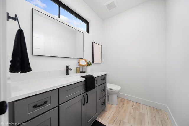 5022 S Lincoln Way, Spokane, WA 99224 - bathroom with vanity, wood finished floors, toilet, and baseboards