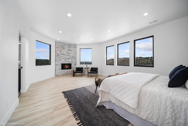 5022 S Lincoln Way, Spokane, WA 99224 - bedroom featuring light wood-type flooring, a stone fireplace, recessed lighting, and baseboards