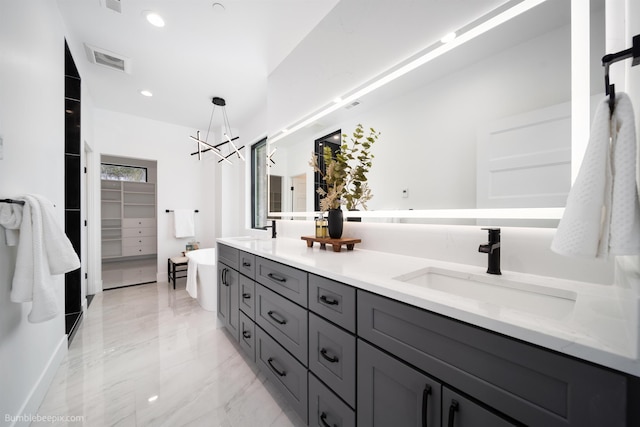 5022 S Lincoln Way, Spokane, WA 99224 - bathroom with double vanity, a chandelier, marble finish floors, a walk in closet, and a freestanding bath