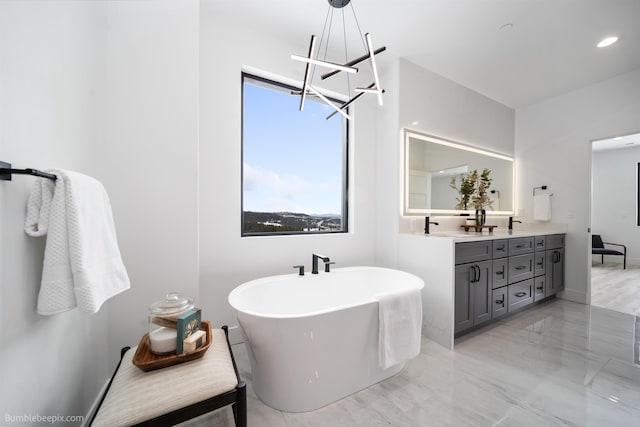 5022 S Lincoln Way, Spokane, WA 99224 - bathroom featuring double vanity, a freestanding tub, a chandelier, and marble finish flooring