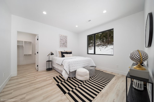 5022 S Lincoln Way, Spokane, WA 99224 - bedroom with light wood-style flooring, recessed lighting, a walk in closet, and baseboards