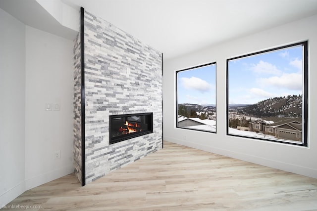 5022 S Lincoln Way, Spokane, WA 99224 - unfurnished living room with a fireplace, wood finished floors, and baseboards
