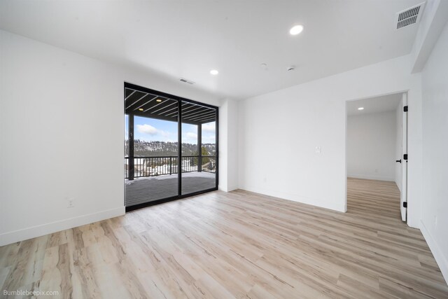 5022 S Lincoln Way, Spokane, WA 99224 - spare room featuring light wood-style flooring, recessed lighting, baseboards, and a wall of windows