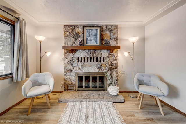 living area with wood-type flooring and a fireplace