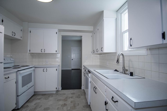 kitchen featuring white cabinetry, white appliances, and sink