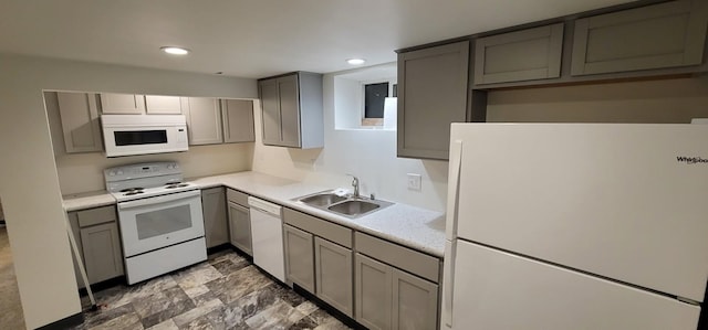 kitchen featuring white appliances, sink, and gray cabinets