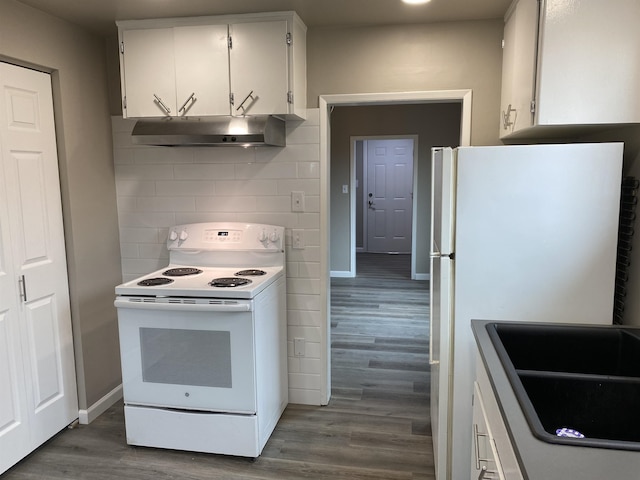 kitchen with white appliances, white cabinetry, dark wood-type flooring, and tasteful backsplash