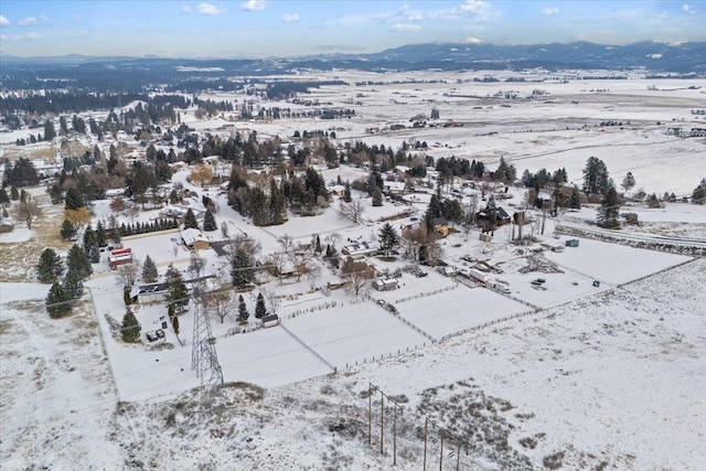 snowy aerial view with a mountain view