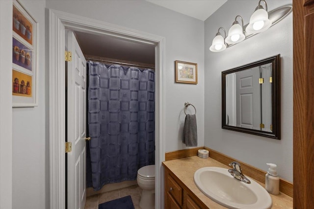 bathroom with vanity, tile patterned flooring, toilet, and walk in shower