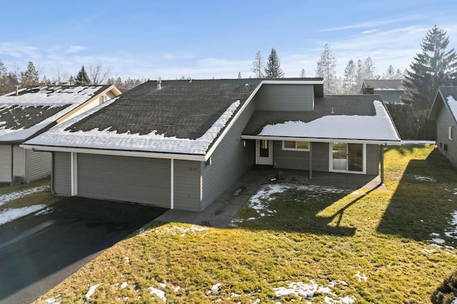 view of front of property featuring a garage and a front yard