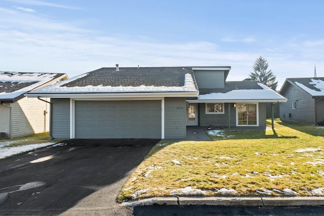 ranch-style house with a garage and a front yard