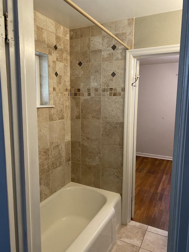 bathroom with tile patterned floors and tiled shower / bath