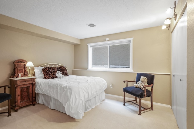 carpeted bedroom featuring a textured ceiling